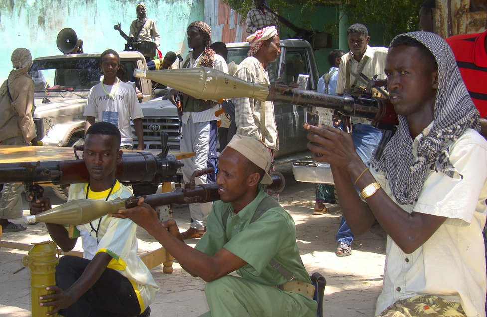 Somali fighters belonging to Ahlusunah warjama, a moderate sect fighting against the hardline al-Shabaab insurgents, display weapons during a parade in Mogadishu July 31, 2010. Al-Shabaab, which is linked to Al Qaeda, controls much of southern Somalia and is fighting to topple the Western-backed government in the lawless Horn of Africa nation. REUTERS/Omar Faruk