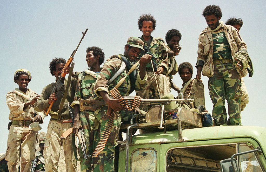 Jubilant Eritrean troops show off their weapons after recapturing the western Eritrean town of Tesseney from Ethiopian forces June 6. The Eritrean government said on Tuesday it had recaptured the town from Ethiopian forces after a day-long battle which forced thousands more civilians from their homes, adding to the region's humanitarian crisis.