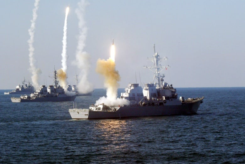 Image: US ships firing missiles. Wikimedia Commons/public domain.