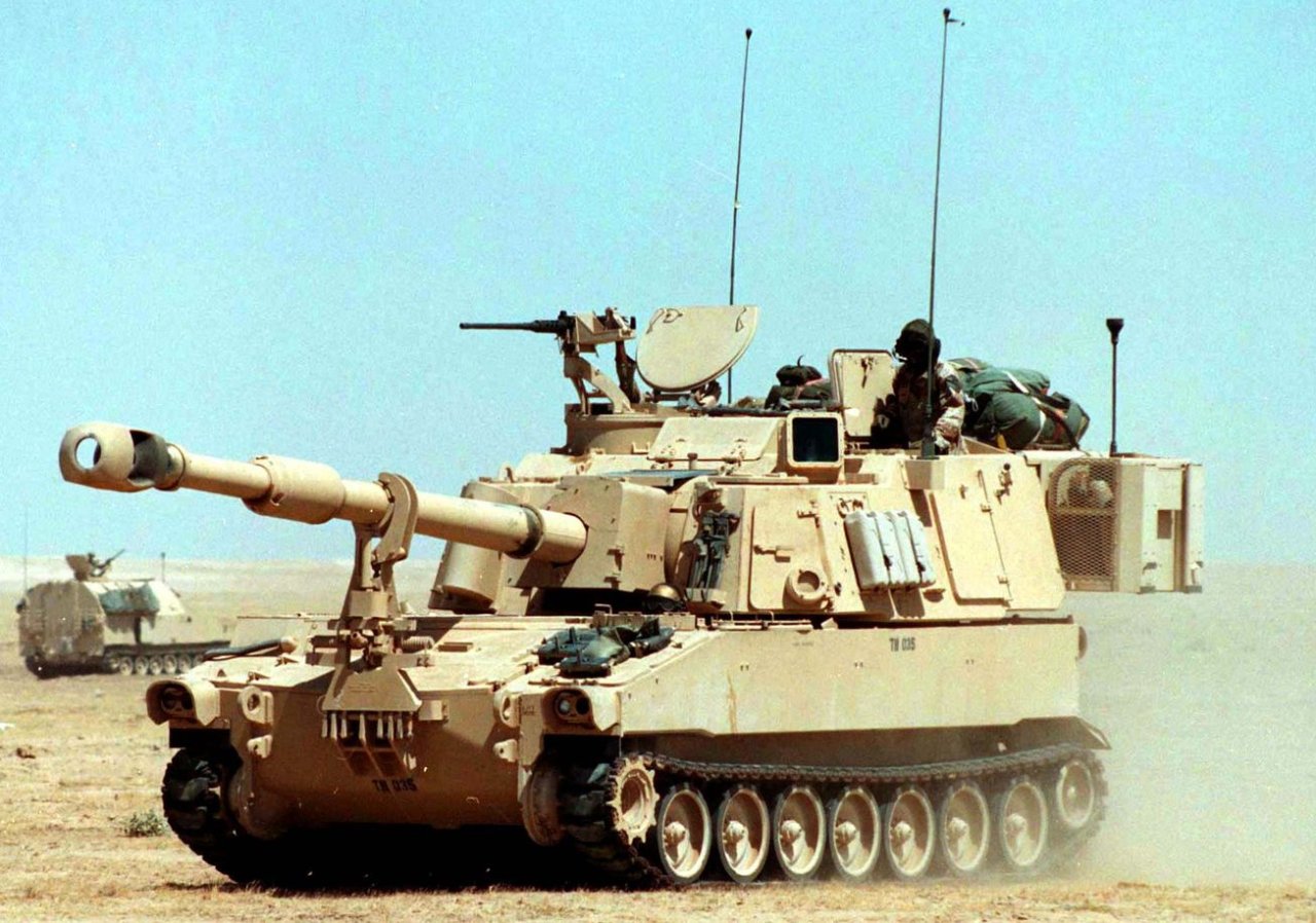 M109A6 Paladin artillery vehicles sporting tan color on military tanks