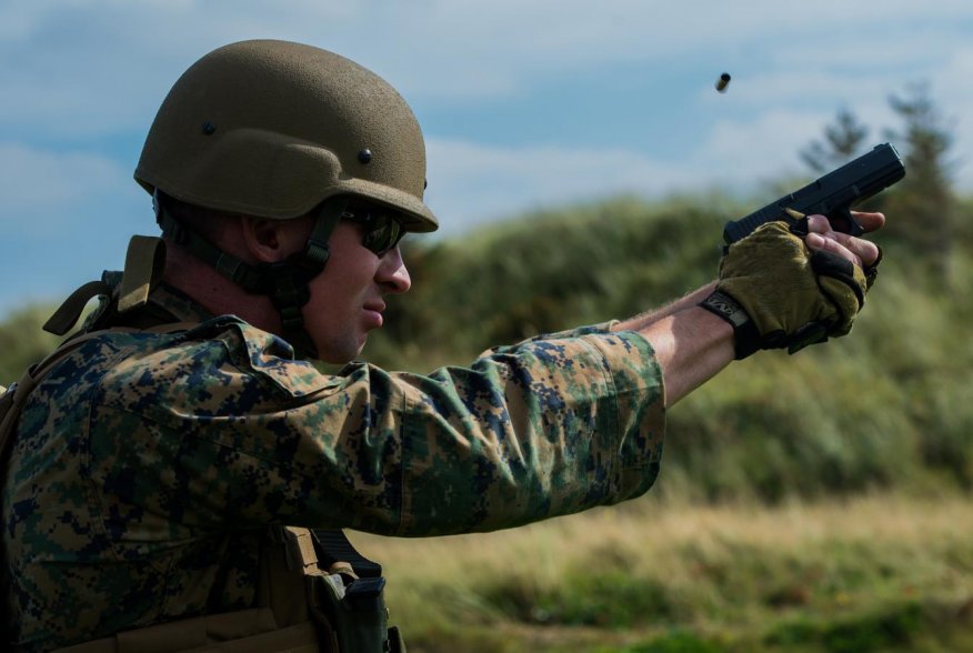 Sgt. Devin Hughes, a member of the Marine Corps Shooting Team, fires a round at a target during the Royal Marines Operational Shooting Competition at Altcar Range near Hightown, England, Sept. 8, 2014. (U.S. Marine Corps photo by Cpl. Cameron Storm/Releas