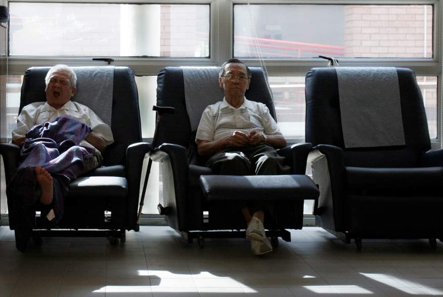 Patients Chung Kong Tuck (L), 72, and Wong Hong Jee, 85, rest at the HCA Day Care Centre in Singapore September 19, 2007. Every week, around 50 elderly terminally ill patients spend the day at the centre, where they participate in rehabilitative and socia