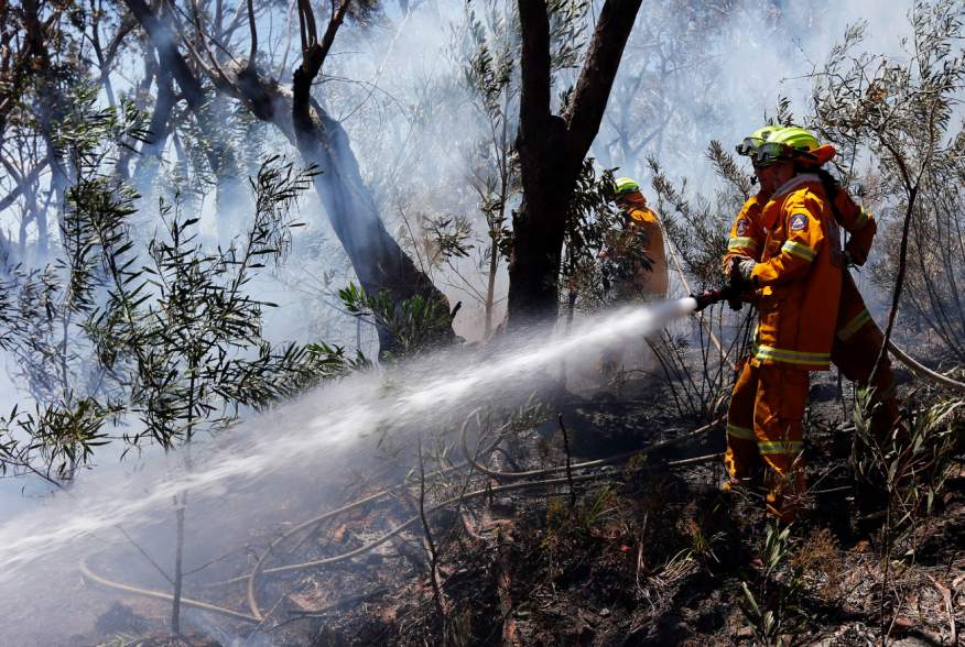 Rural Fire Service (RFS) firefighters try to extinguish a small fire approaching homes near the Blue Mountains suburb of Blackheath, located around 70 kilometres (44 miles) west of Sydney October 23, 2013. 