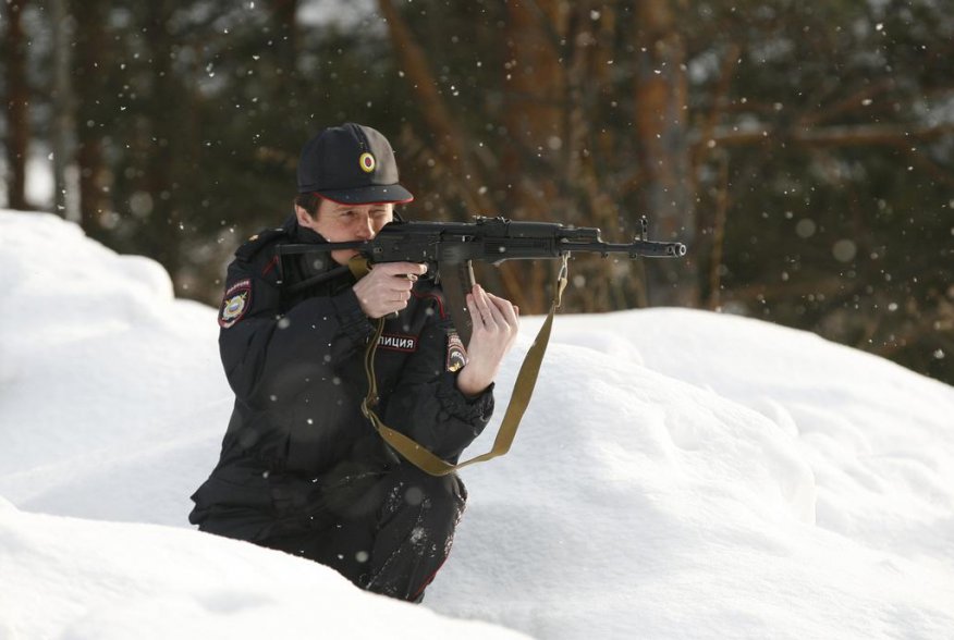 Special task force police officer Irina Samit, who is also an instructor, aims with a Kalashnikov AK-47 rifle as she takes part in a training session in the suburbs of Russia's Siberian city of Krasnoyarsk, March 6, 2014. REUTERS/Ilya Naymushin