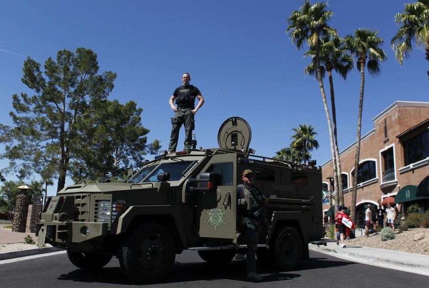 A Maricopa County, Arizona police SWAT team with an armored vehicle stand guard outside a campaign rally being held by Republican U.S. presidential candidate Donald Trump in Fountain Hills, Arizona March 19, 2016. REUTERS/Ricardo Arduengo