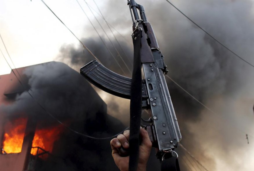 A Kurdish gunman holds a AK-47 rifle in front of a Shi'ite militiaman house during clashes Tuz Khurmato, Iraq, April 24, 2016. REUTERS/Goran Tomasevic