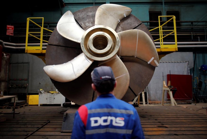 An employee looks at the propeller of a Scorpen submarine at the industrial site of the naval defence company and shipbuilder DCNS in La Montagne near Nantes, France, April 26, 2016. REUTERS/Stephane Mahe TPX IMAGES OF THE DAY