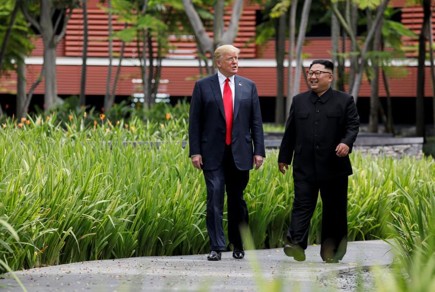 U.S. President Donald Trump and North Korea's leader Kim Jong Un walk together before their working lunch during their summit at the Capella Hotel on the resort island of Sentosa, Singapore June 12, 2018. Picture taken June 12, 2018. REUTERS/Jonathan Erns