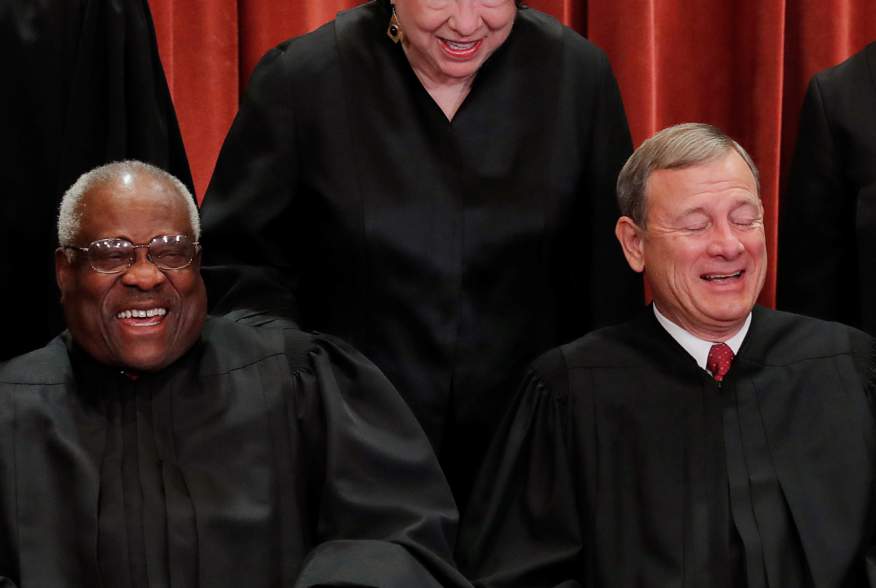 U.S. Supreme Court Associate Justice Sonia Sotomayor makes Associate Justice Clarence Thomas and Chief Justice John Roberts laugh as they pose together for their group portrait at the Supreme Court in Washington, U.S., November 30, 2018. REUTERS/Jim Young