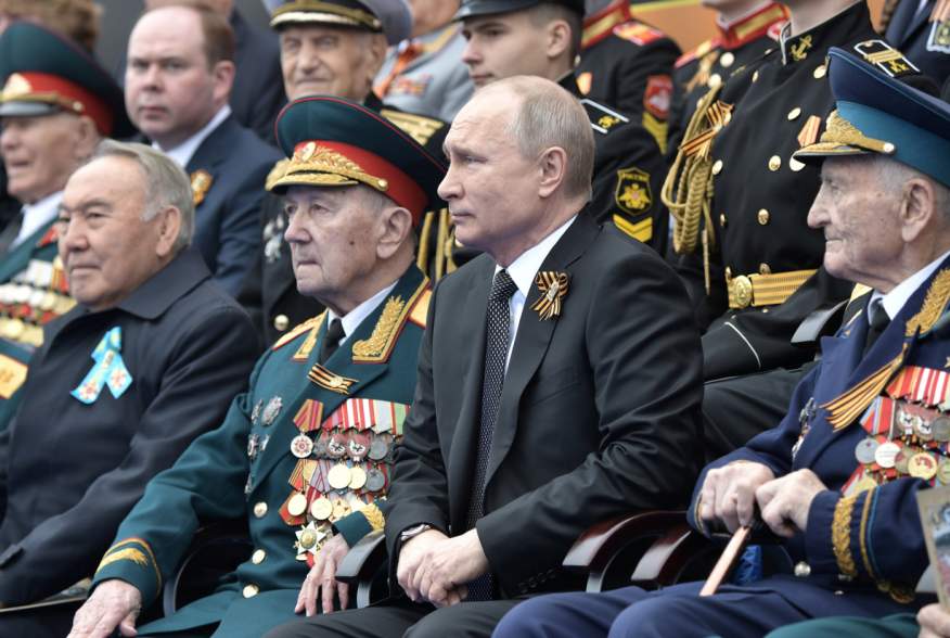 Spectators, including Russia's President Vladimir Putin and Kazakhstan's Former President Nursultan Nazarbayev, attend the Victory Day parade, which marks the anniversary of the victory over Nazi Germany in World War Two, in Red Square in central Moscow, 