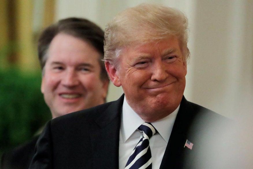 U.S. President Donald Trump smiles next to U.S. Supreme Court Associate Justice Brett Kavanaugh as they participate in a ceremonial public swearing-in in the East Room of the White House in Washington, U.S., October 8, 2018. REUTERS/Jim Bourg