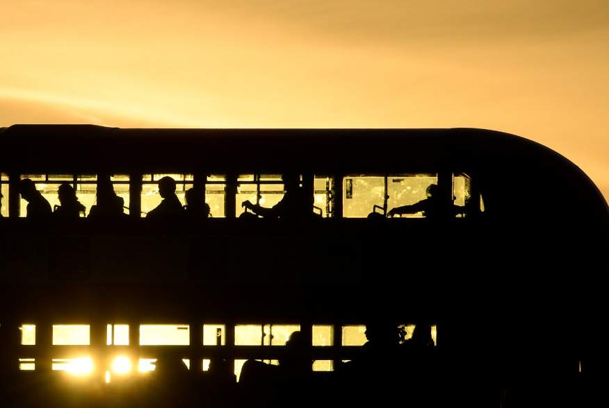 Workers are seen crossing London Bridge in a bus at sunrise in London, Britain, September 25, 2018. Picture taken September 25, 2018. To match Exclusive BRITAIN-EU/CITY REUTERS/Toby Melville