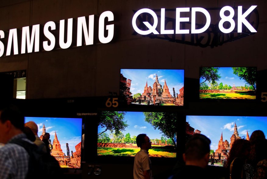 People stand in front of the QLED 8K screens at the hall of Samsung at the IFA consumer tech fair in Berlin, Germany, September 6, 2019. REUTERS/Hannibal Hanschke