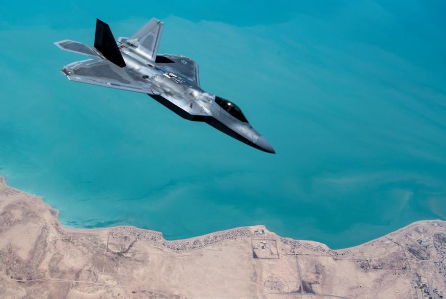A U.S. F-22 Raptor, based out of Al Udeid Base in Doha, Qatar, receives fuel from a 28th Expeditionary Air Refuelling Squadron KC-135 Stratotanker during a combat air patrol mission over an undisclosed location in Southwest Asia, in this picture taken Sep