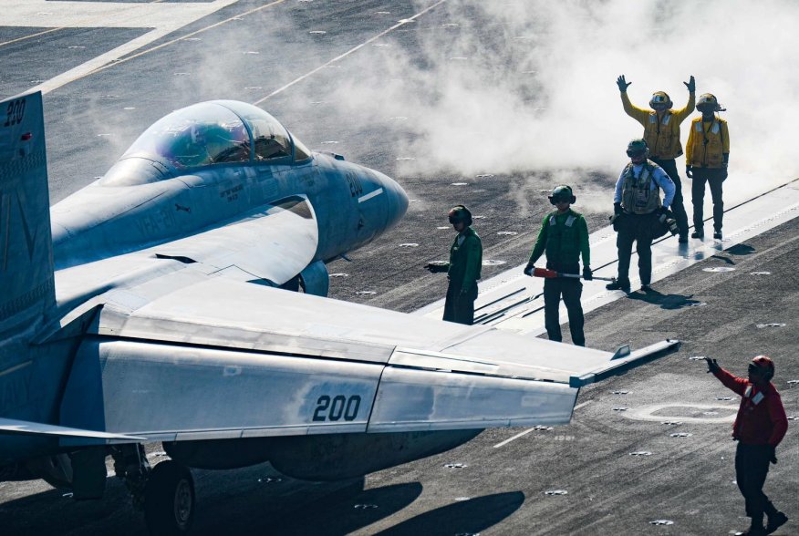 Sailors carry out pre-flight checks on an F/A-18F Super Hornet on the flight deck of the U.S. Navy aircraft carrier USS Harry S. Truman in the Arabian Sea January 6, 2020. Picture taken January 6, 2020. U.S. Navy/Mass Communication Specialist 3rd Class Ka