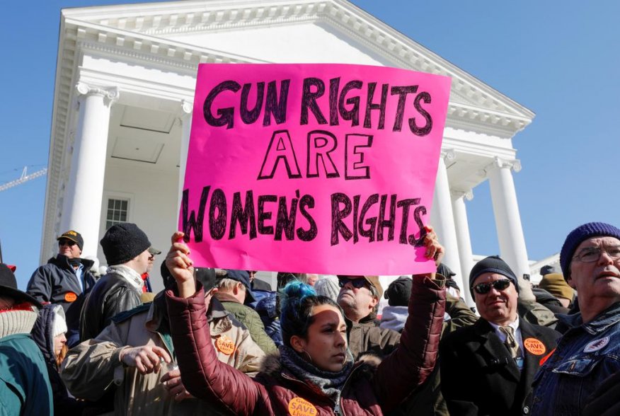 A activist holds up a sign supporting gun rights for women during a rally inside the no-gun zone in front of the Virginia State Capitol building in Richmond, Virginia, U.S. January 20, 2020. REUTERS/Jonathan Drake