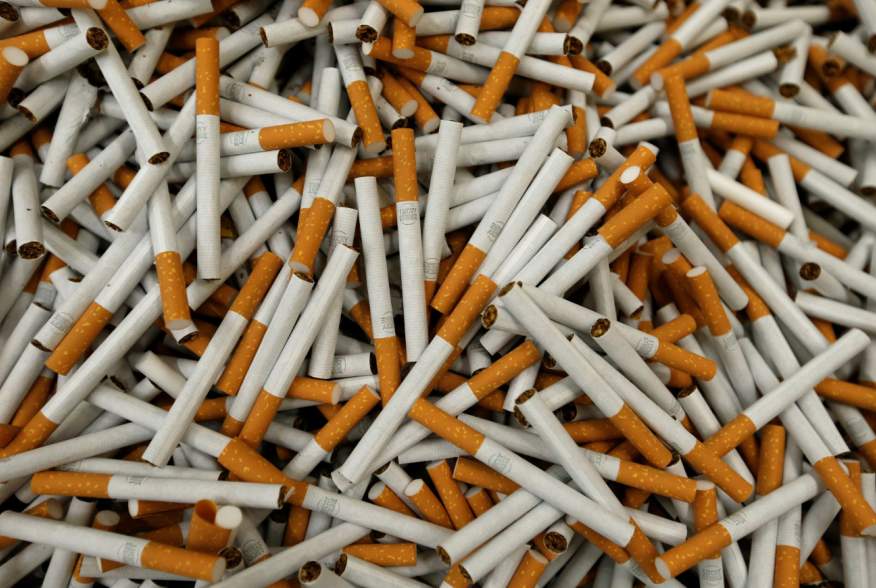 FILE PHOTO: Cigarettes are seen during the manufacturing process in the British American Tobacco Cigarette Factory (BAT) in Bayreuth, southern Germany, April 30, 2014. Picture taken April 30, 2014. REUTERS/Michaela Rehle/File Photo