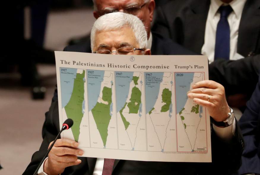 Palestinian President Mahmoud Abbas holds a document while speaking during a Security Council meeting at the United Nations in New York, U.S., February 11, 2020. REUTERS/Shannon Stapleton