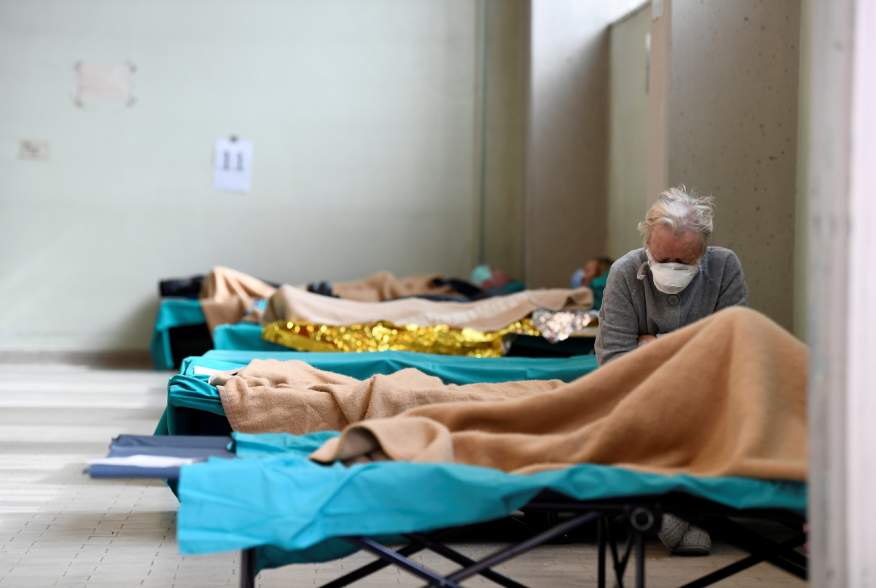 A patient is seen sitting inside the Spedali Civili hospital in Brescia, Italy March 13, 2020. REUTERS/Flavio Lo Scalzo