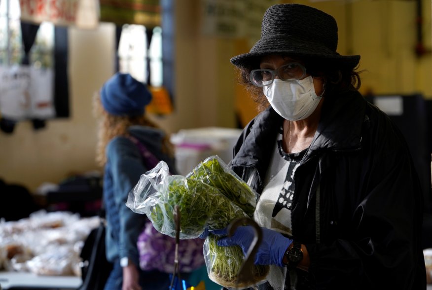 Dee Freeland buys fresh herbs at the Farmers Public Market in Oklahoma City, Oklahoma, U.S., March 21, 2020. Picture taken March 21, 2020. REUTERS/Nick Oxford
