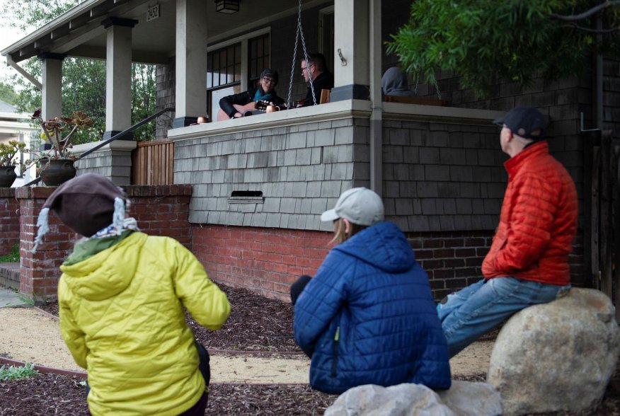 Musicians perform as part of a series of porch concerts during the lockdown against the spread of coronavirus disease (COVID-19) in Alameda, California, U.S. March 27, 2020. REUTERS/Kate Munsch