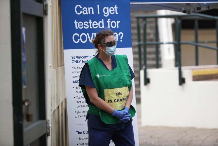A healthcare professional waits at a pop-up clinic testing for the coronavirus disease (COVID-19) at Bondi Beach, after several outbreaks were recorded in the area, in Sydney, Australia April 1, 2020. REUTERS/Loren Elliott