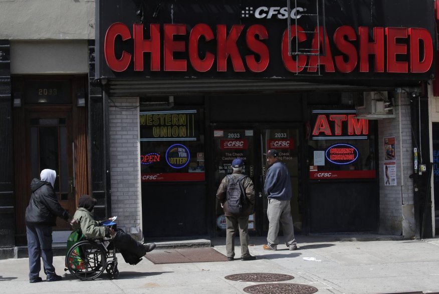 People line-up outside a check cashing and bill pay location as New York residents' rent becomes due on the first of the month in Manhattan during the outbreak of the coronavirus disease (COVID-19) in New York City, New York, U.S., April 1, 2020. REUTERS/