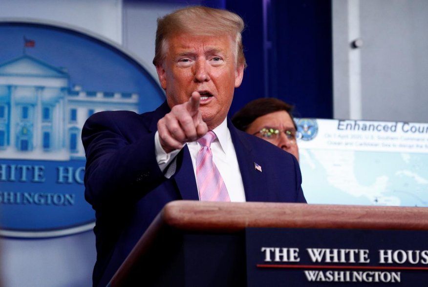 U.S. President Donald Trump addresses the daily coronavirus response briefing as Defense Secretary Mark Esper listens at the White House in Washington, U.S., April 1, 2020. REUTERS/Tom Brenner