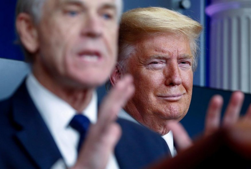 U.S. President Donald Trump listens as White House Director of Trade and Marketing Policy Peter Navarro addresses the daily coronavirus response briefing at the White House in Washington, U.S., April 2, 2020. REUTERS/Tom Brenner.