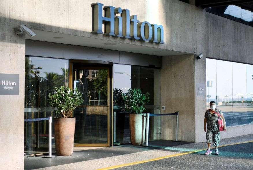 A resident walks past the Hilton Copacabana Hotel, that is temporarily closed, amid the coronavirus disease (COVID-19) outbreak, in Rio de Janeiro, Brazil, April 3, 2020. REUTERS/Lucas Landau
