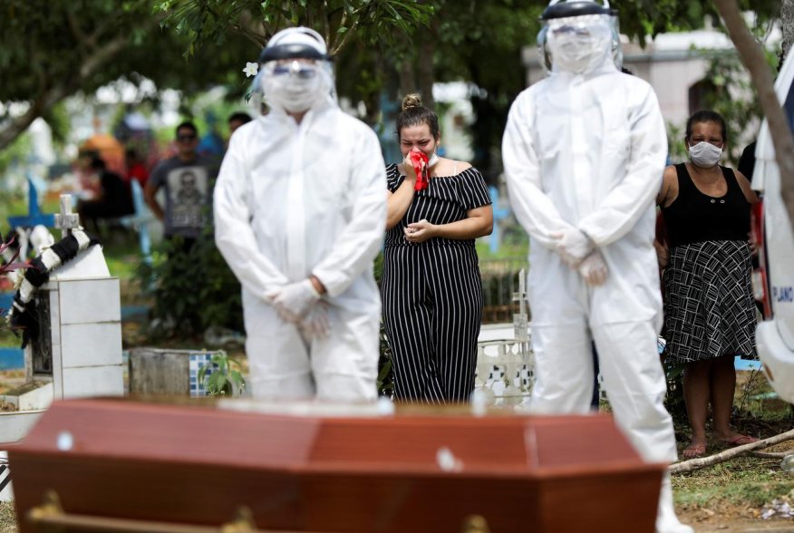 Relatives of 68-years-old Natalina Cardoso Bandeira, who passed away due to coronavirus disease (COVID-19), react during her burial at the Parque Taruma cemetery in Manaus, Brazil, April 10, 2020. REUTERS/Bruno Kelly