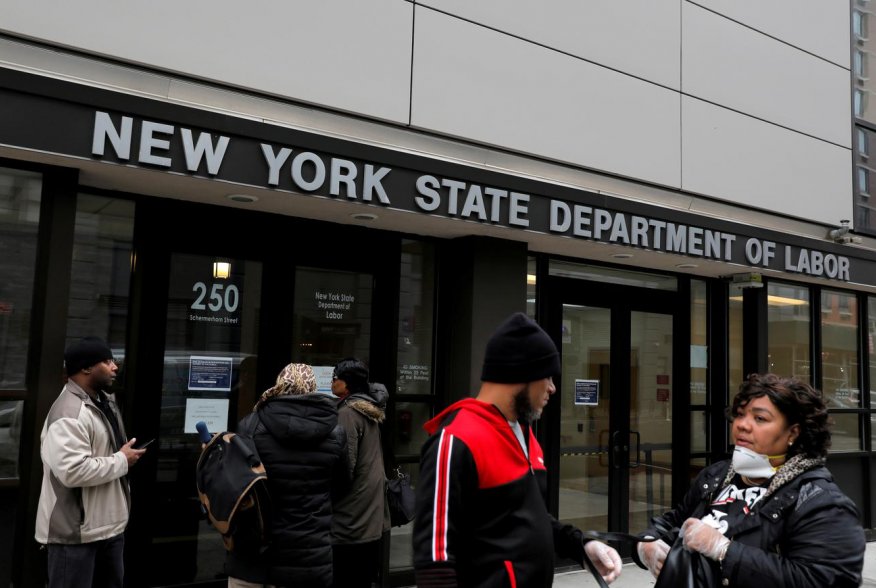 People gather at the entrance for the New York State Department of Labor offices, which closed to the public due to the coronavirus disease (COVID-19) outbreak in the Brooklyn borough of New York City, U.S., March 20, 2020. REUTERS/Andrew Kelly