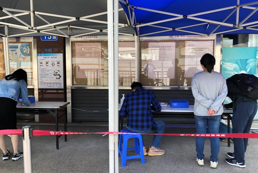 Residents fill out registration data ahead of coronavirus checks outside a local hospital in Guangzhou's Sanyuanli area, as the spread of the novel coronavirus disease (COVID-19) continues in the country, in Guangdong province, China April 13, 2020. REUTE