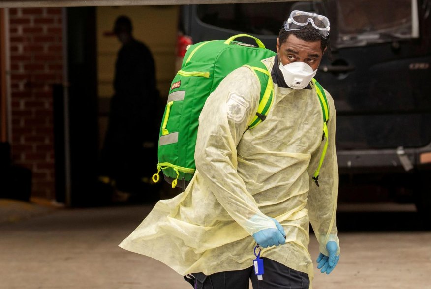 An Emergency Medical Technician (EMT) wearing personal protective equipment (PPE) walks out of the Cobble Hill Health Center nursing home during the ongoing outbreak of the coronavirus disease (COVID-19) in the Brooklyn borough of New York, U.S., April 17