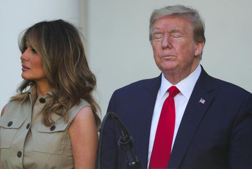 First lady Melania Trump stands with U.S. President Donald Trump as he closes his eyes during the White House National Day of Prayer Service in the Rose Garden at the White House in Washington, U.S., May 7, 2020. REUTERS/Tom Brenner