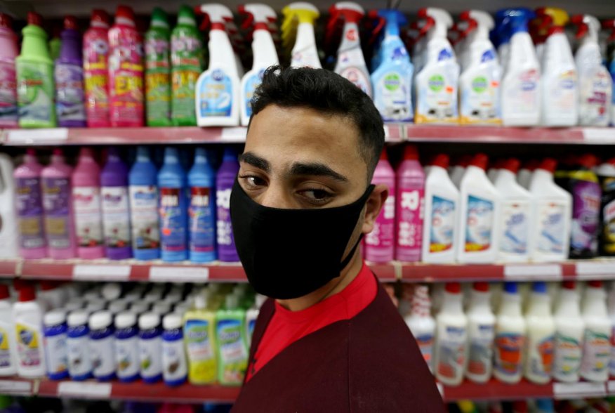 A Palestinian man wearing a mask looks on as he stands in front of disinfectants and cleaning products in a supermarket amid the coronavirus disease (COVID-19) crisis, in the southern Gaza Strip June 9, 2020. REUTERS/Ibraheem Abu Mustafa