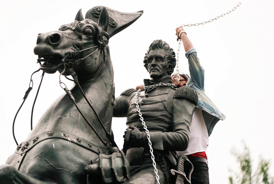 A protestor wraps chains around the neck of the statue of U.S. President Andrew Jackson during an attempt by protestors to pull the statue down in the middle of Lafayette Park in front of the White House during racial inequality protests in Washington, D.