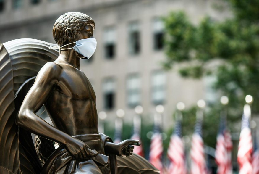 The Mankind Figure of Youth statue at Rockefeller Center in Manhattan is seen adorned with a face mask following the outbreak of the coronavirus disease (COVID-19), in New York City, New York, U.S., July 5, 2020. REUTERS/Jeenah Moon