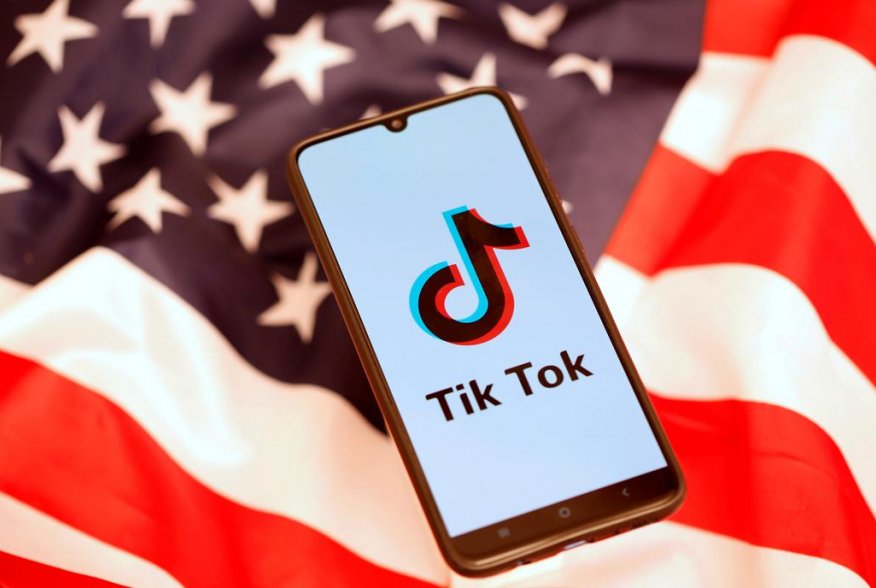 TikTok logo is displayed on the smartphone while standing on the U.S. flag in this illustration picture taken, November 8, 2019. REUTERS/Dado Ruvic