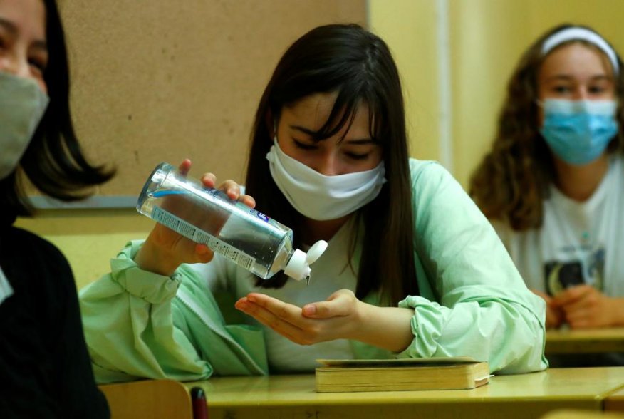 A pupil of the protestant high school "Zum Grauen Kloster" disinfects her hands during a lesson on the first day after the summer holidays, amid the coronavirus disease (COVID-19) pandemic, in Berlin, Germany, August 10, 2020. REUTERS/Fabrizio Bensch
