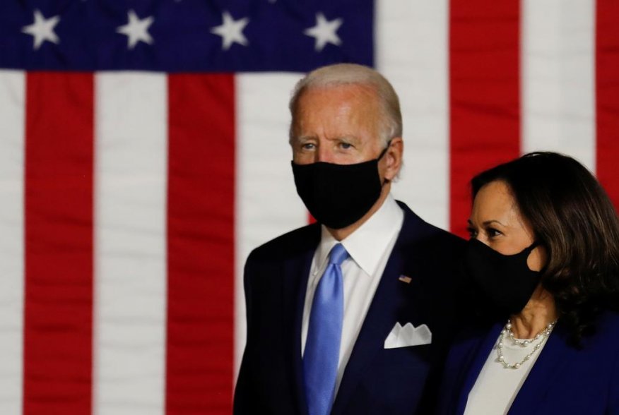 Democratic presidential candidate and former Vice President Joe Biden and vice presidential candidate Senator Kamala Harris take the stage at a campaign event, their first joint appearance since Biden named Harris as his running mate, at Alexis Dupont Hig