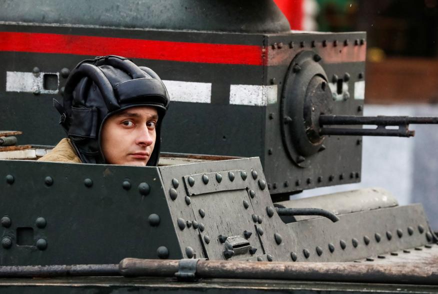 A Russian Army member rides in a historical tank, during a rehearsal for a military parade to mark the anniversary of a historical parade in 1941, when Soviet soldiers marched towards the front lines at the Red Square in Moscow, Russia November 5, 2017. R