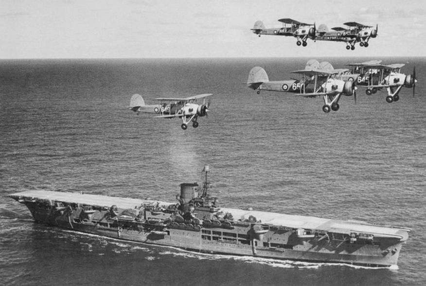  British aircraft carrier Ark Royal with a flight of "Swordfish" overhead, circa 1939. Courtesy of Donald M. McPherson, 1977.