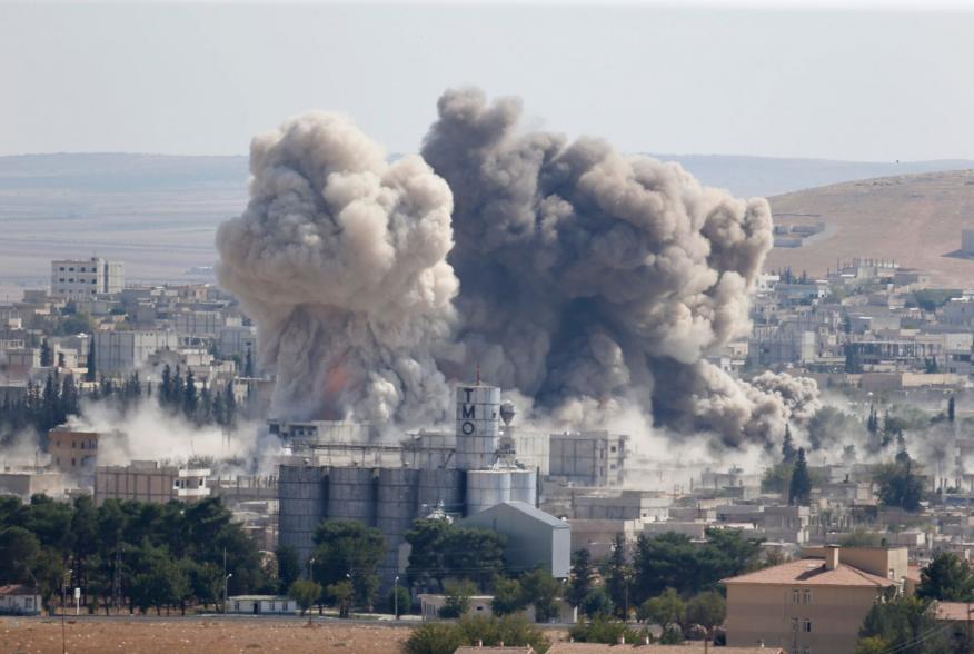 Smoke rises after an U.S.-led air strike in the Syrian town of Kobani Ocotber 8, 2014. U.S.-led air strikes on Wednesday pushed Islamic State fighters back to the edges of the Syrian Kurdish border town of Kobani, which they had appeared set to seize afte