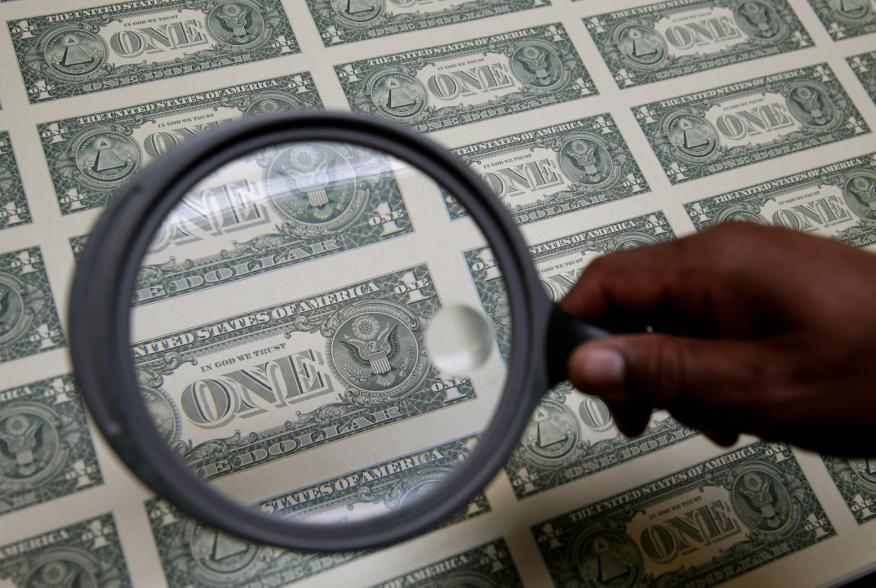 United States one dollar bills are inspected under a magnifying glass during production at the Bureau of Engraving and Printing in Washington November 14, 2014. REUTERS/Gary Cameron 