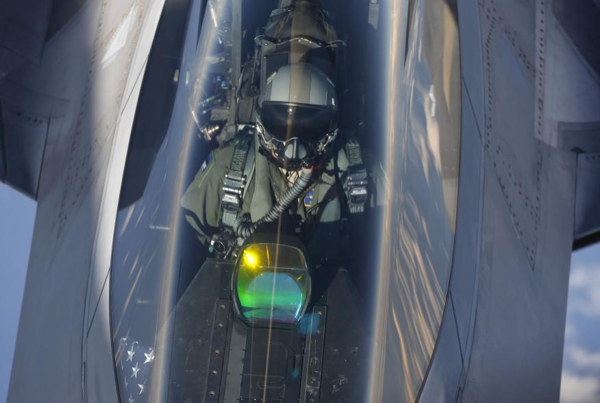 The head-up display of a F-22 Raptor fighter jet reflects the sun light as a pilot of the 95th Fighter Squadron from Tyndall, Florida is seen during refuelling by a KC-135 Stratotanker from the 100th Air Refueling Wing at the Royal Air Force Base in Milde