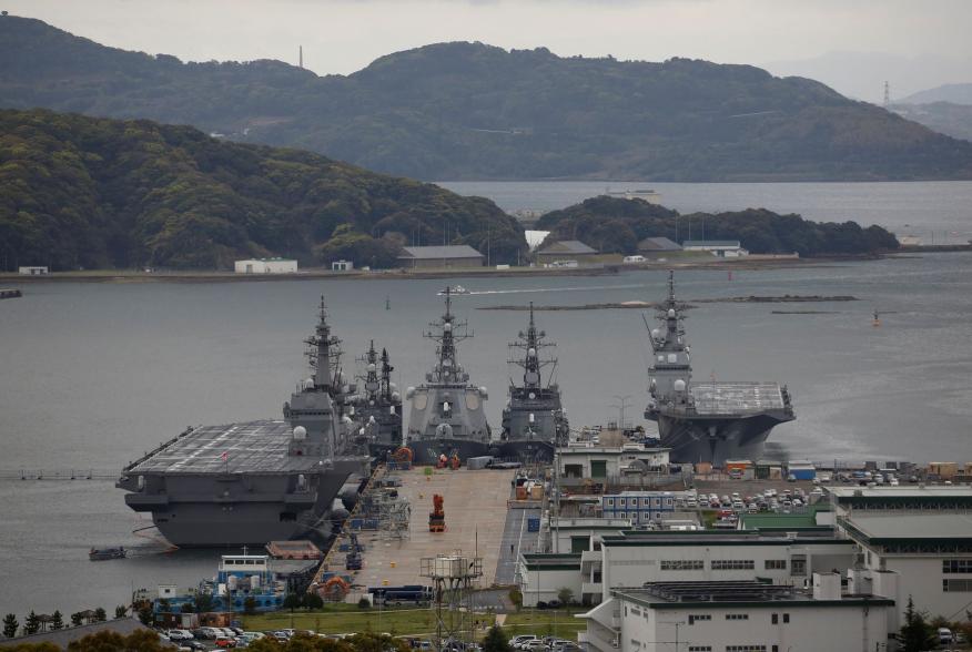 Japan Maritime Self-Defense Force's (JMSDF) latest Izumo-class helicopter carrier DDH-184 Kaga (L) and other JMSDF destroyers DD-157 Sawagari, DDG-176 Chokai, DD-104 Kirisame and DDH-182 Ise are moored at a naval base in Sasebo, on the southwest island of