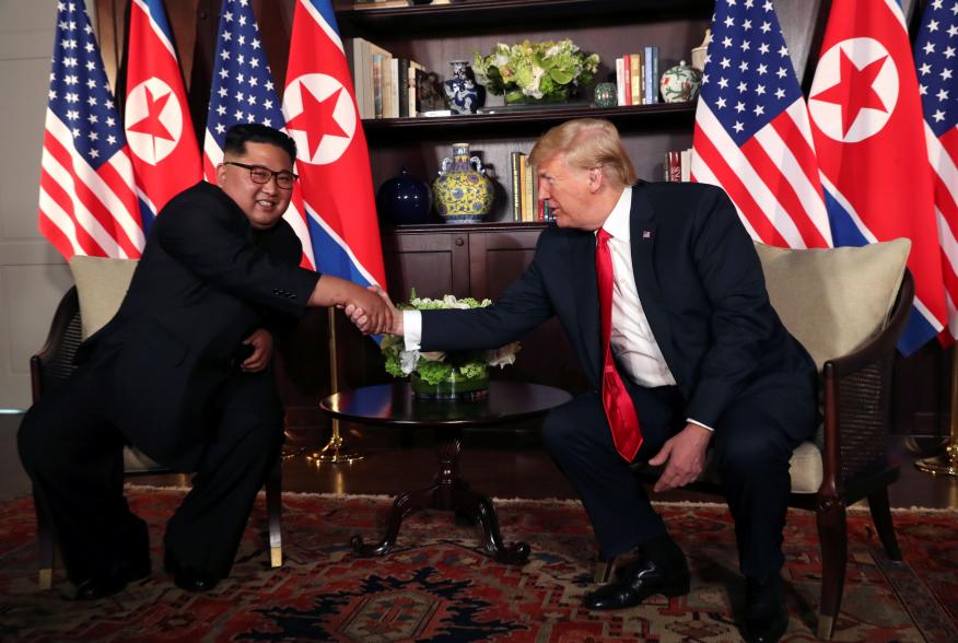 U.S. President Donald Trump shakes hands with North Korea's leader Kim Jong Un before their bilateral meeting at the Capella Hotel on Sentosa island in Singapore June 12, 2018. REUTERS/Jonathan Ernst