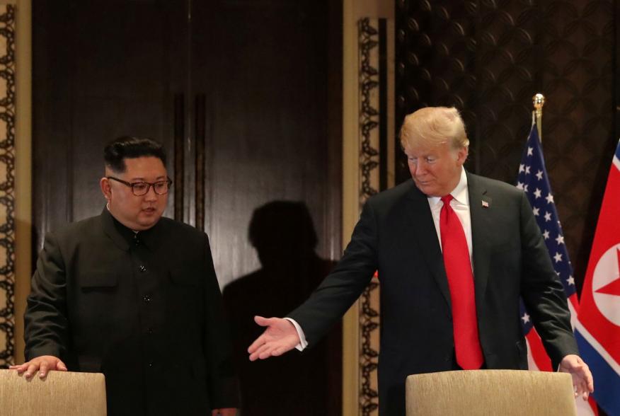 U.S. President Donald Trump and North Korea's leader Kim Jong Un arrive to sign a document to acknowledge the progress of the talks and pledge to keep momentum going, after their summit at the Capella Hotel on Sentosa island in Singapore June 12, 2018. RE