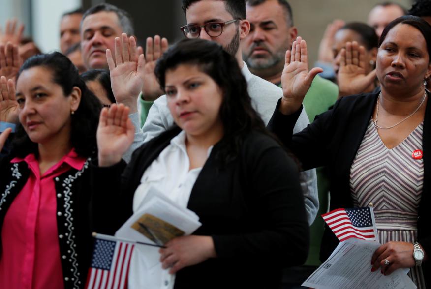 Immigrants take the Oath of Allegiance to become a U.S. citizens during an official Naturalization Ceremony at the Museum of Fine Arts, Boston in Boston, Massachusetts, U.S., May 6, 2019. REUTERS/Brian Snyder